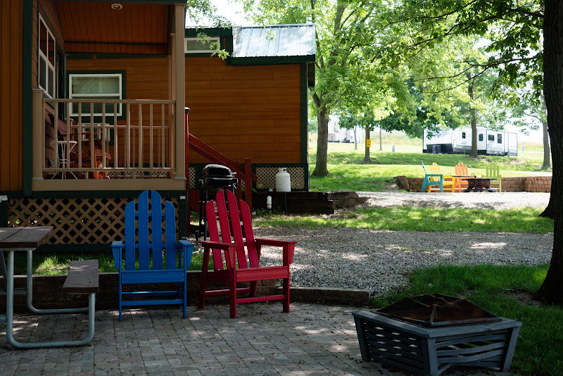 Fire pit and Adirondack chairs outside a deluxe cabin at Alta Campground
