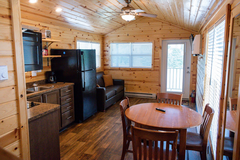 Open kitchenette, dining area, and living space inside a deluxe cabin at Alta Campground