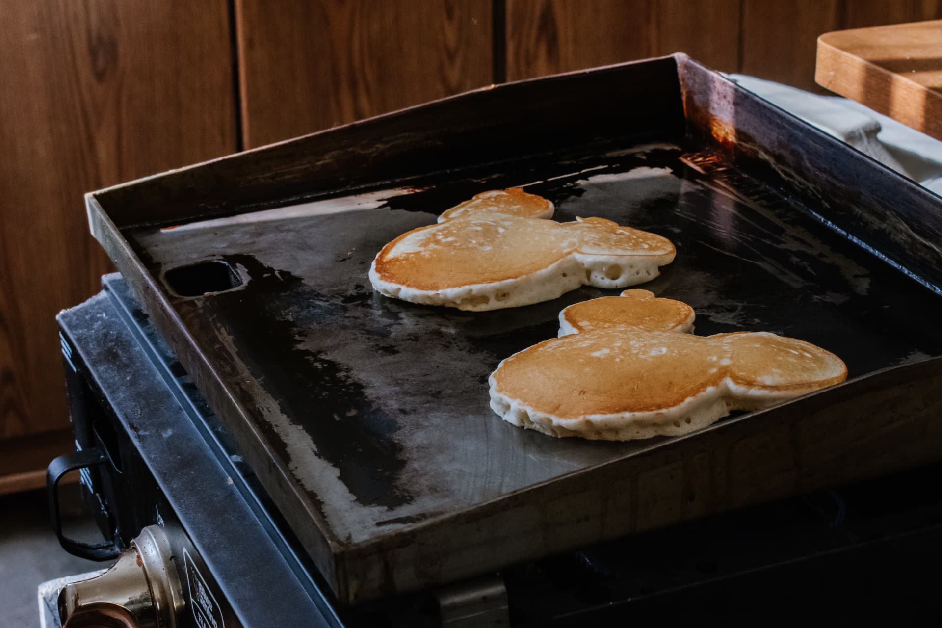 Fresh pancakes cooking on the griddle for Saturday breakfast